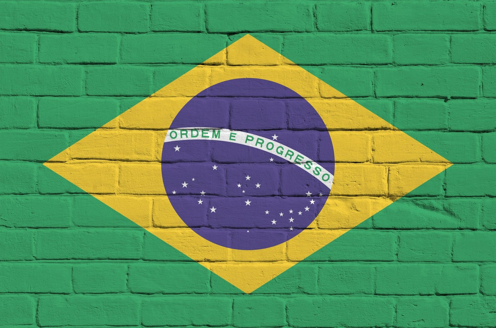 Brazil flag depicted in paint colors on old brick wall close up